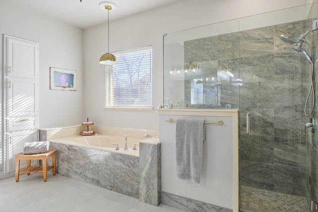 bathroom with a shower stall and a bath