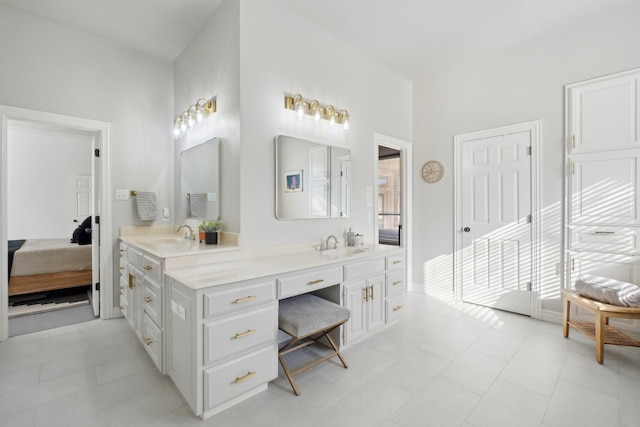 bathroom with a sink, double vanity, and connected bathroom