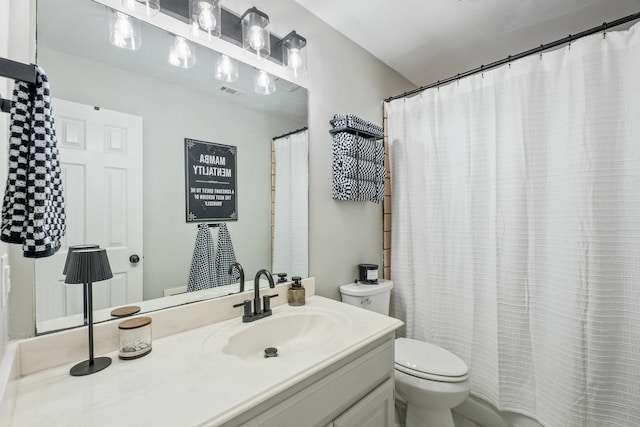 bathroom featuring vanity, curtained shower, toilet, and visible vents