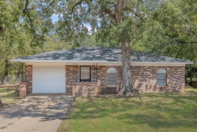 single story home featuring a garage, concrete driveway, brick siding, and a front lawn