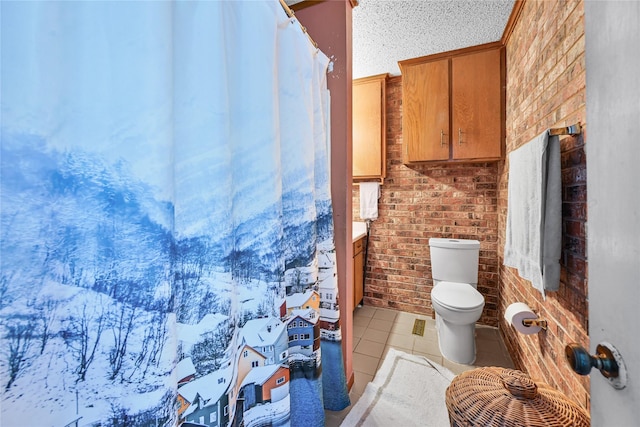 full bathroom with toilet, a shower with curtain, brick wall, tile patterned flooring, and a textured ceiling