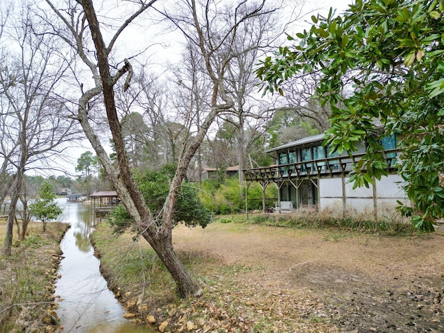 view of yard featuring a deck with water view