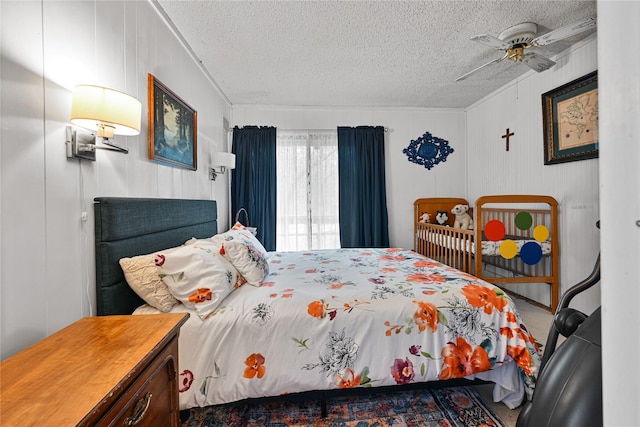 bedroom featuring a ceiling fan and a textured ceiling