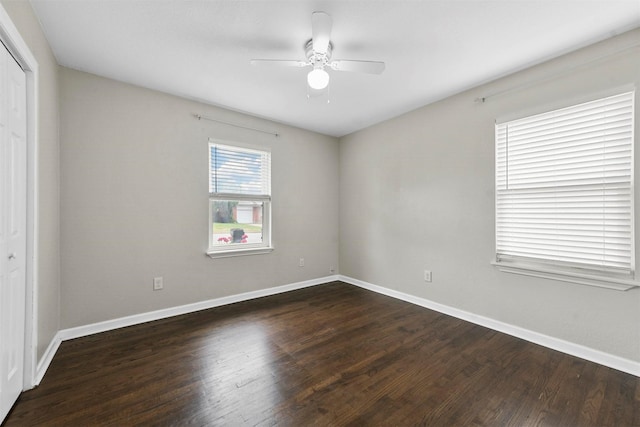 empty room with ceiling fan, baseboards, and wood finished floors