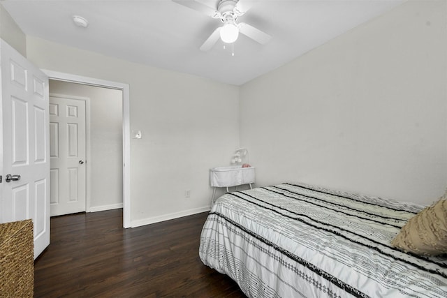 bedroom with a ceiling fan, wood finished floors, and baseboards