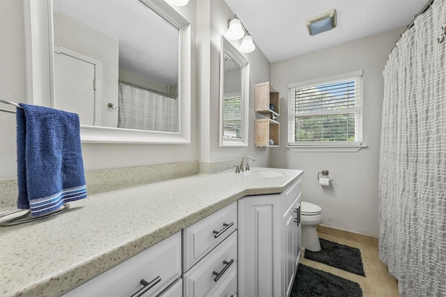 full bath featuring tile patterned floors, baseboards, toilet, and vanity