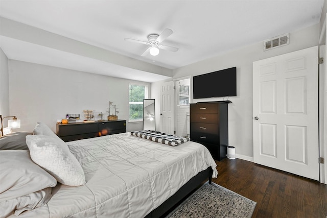 bedroom featuring visible vents, baseboards, dark wood finished floors, and a ceiling fan