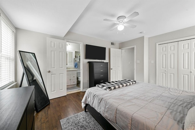 bedroom featuring dark wood-style floors, multiple windows, a closet, and ceiling fan