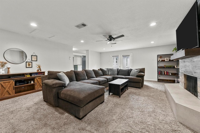 living area with visible vents, light carpet, recessed lighting, a fireplace, and ceiling fan