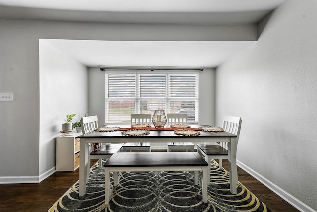 dining room featuring baseboards and wood finished floors