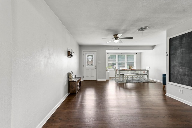 entrance foyer with visible vents, baseboards, a textured ceiling, and wood finished floors