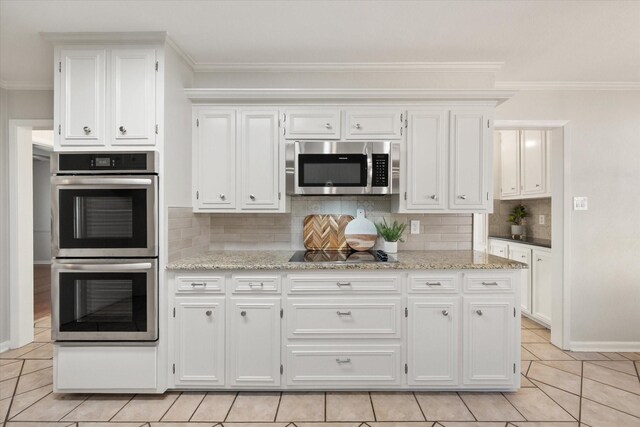 2013 Glenwood Cir, Corsicana, TX 75110 - kitchen with light tile patterned flooring, appliances with stainless steel finishes, a peninsula, ornamental molding, and white cabinetry