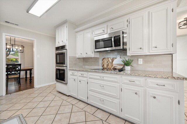 2013 Glenwood Cir, Corsicana, TX 75110 - unfurnished dining area with a chandelier, light tile patterned floors, crown molding, and baseboards
