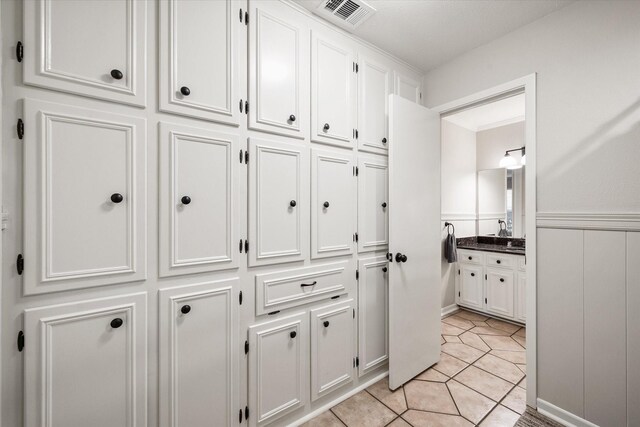 2013 Glenwood Cir, Corsicana, TX 75110 - corridor featuring wainscoting and light tile patterned floors