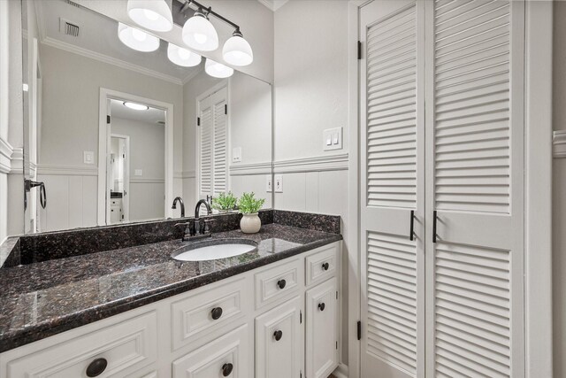 2013 Glenwood Cir, Corsicana, TX 75110 - bathroom with ornamental molding, vanity, and a decorative wall