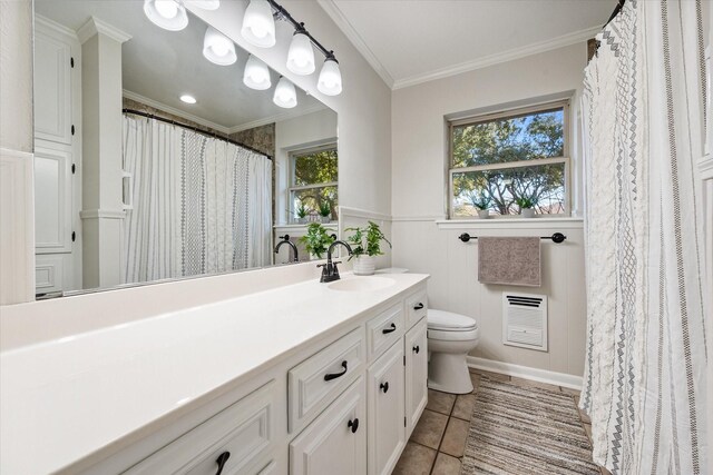 2013 Glenwood Cir, Corsicana, TX 75110 - bathroom featuring vanity, ornamental molding, toilet, tile patterned flooring, and a wainscoted wall