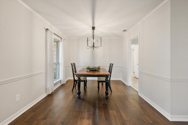 2013 Glenwood Cir, Corsicana, TX 75110 - dining area featuring a chandelier, dark wood-style flooring, ornamental molding, and baseboards