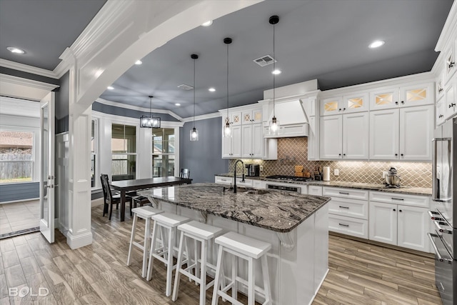 kitchen with white cabinetry and dark stone counters