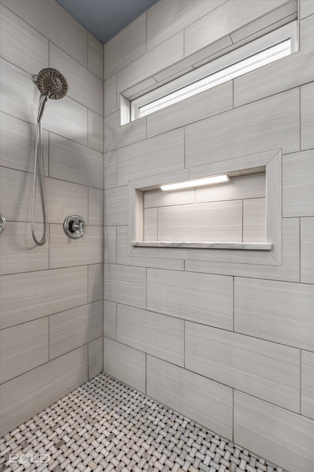 bathroom with tiled shower