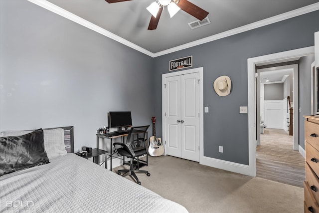 bedroom featuring visible vents, carpet floors, baseboards, and crown molding