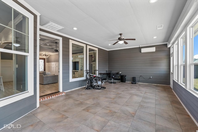 unfurnished sunroom featuring visible vents, a wall mounted AC, and a ceiling fan