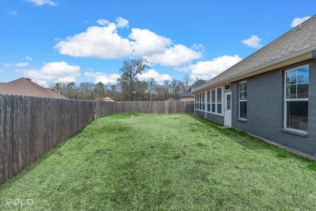 view of yard with a fenced backyard