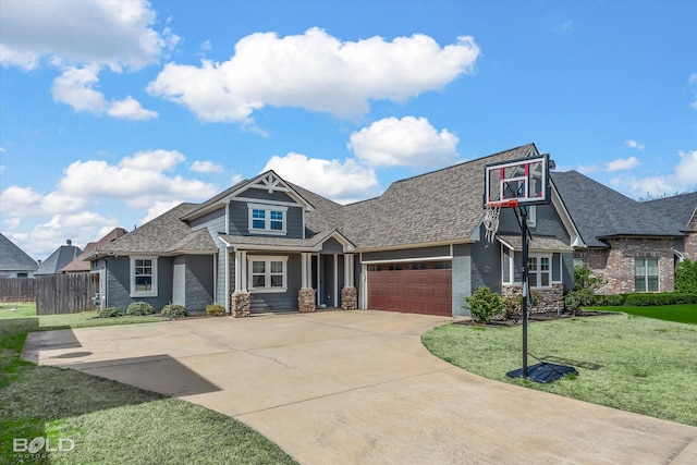 craftsman-style home featuring a front yard, fence, roof with shingles, concrete driveway, and a garage