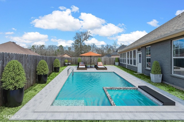 view of swimming pool featuring a patio, a fenced backyard, and a pool with connected hot tub