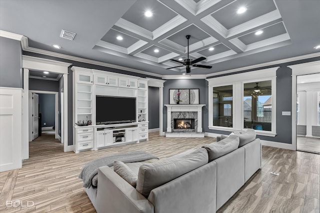 living area featuring light wood-style floors, visible vents, a ceiling fan, and a high end fireplace