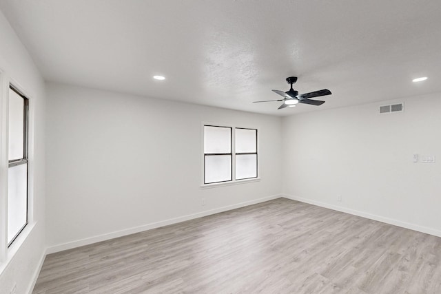 spare room with baseboards, recessed lighting, visible vents, and light wood-style floors