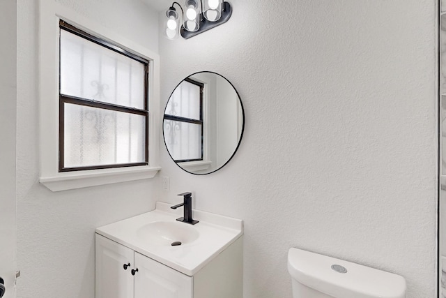 bathroom with toilet and vanity