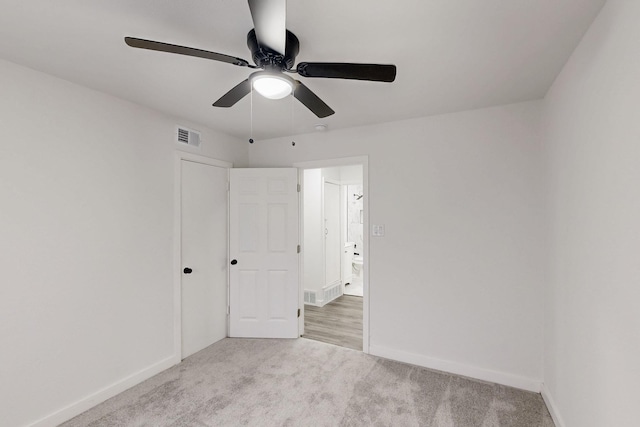 unfurnished bedroom with carpet floors, visible vents, baseboards, and a ceiling fan