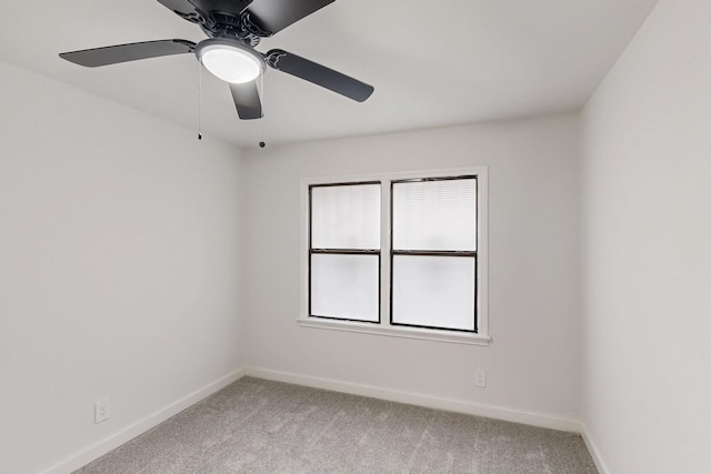 unfurnished room featuring baseboards and light colored carpet