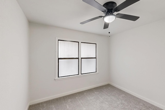 unfurnished room with light carpet, a ceiling fan, and baseboards