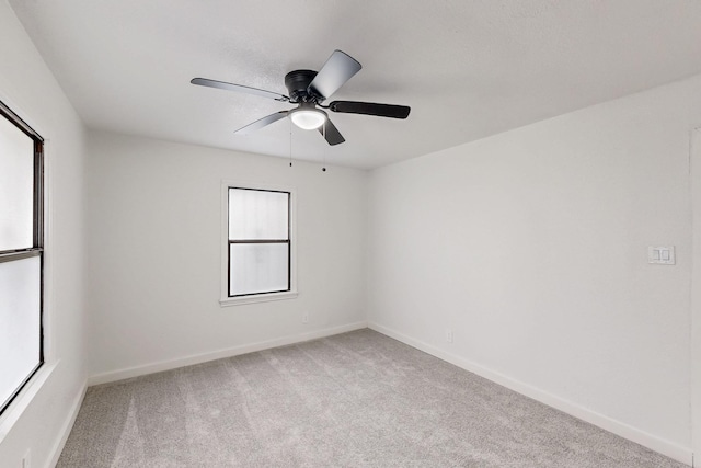 empty room featuring carpet floors, ceiling fan, and baseboards