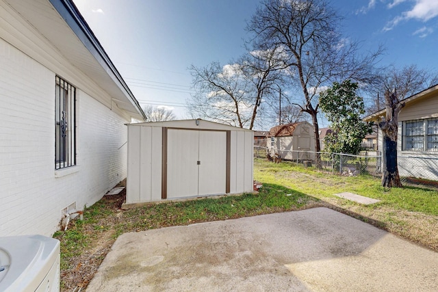 view of yard with a patio, a storage unit, an outdoor structure, and fence