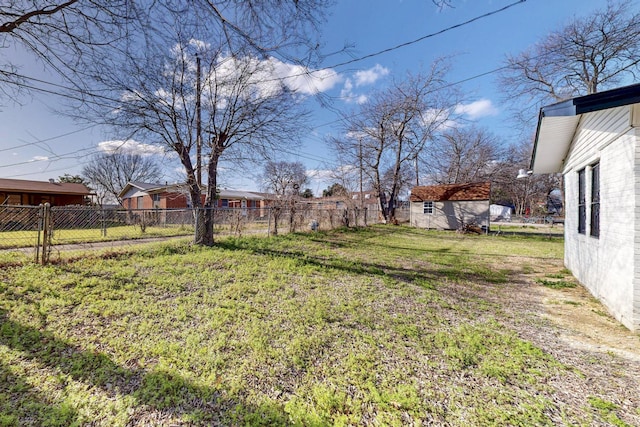 view of yard featuring an outbuilding and fence