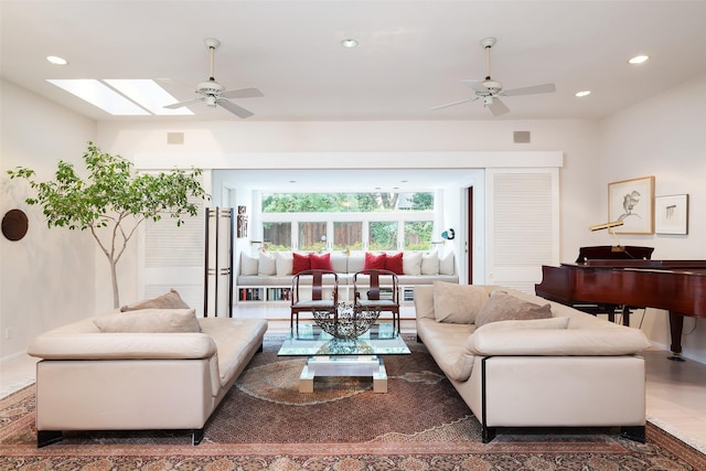 living area with a ceiling fan, recessed lighting, and a skylight