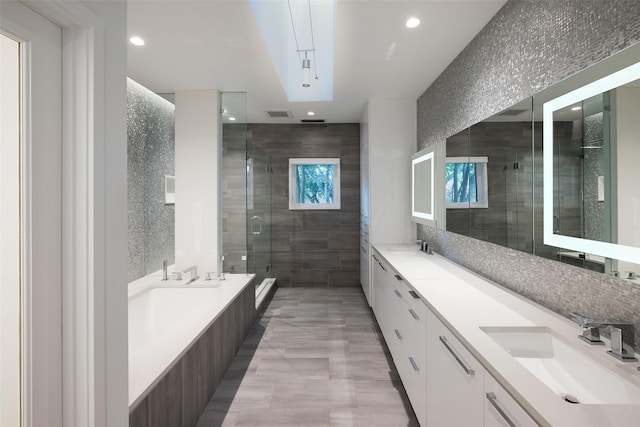 full bathroom featuring double vanity, recessed lighting, a sink, and a shower stall