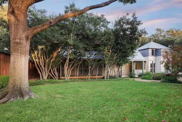 view of yard featuring a sunroom and fence