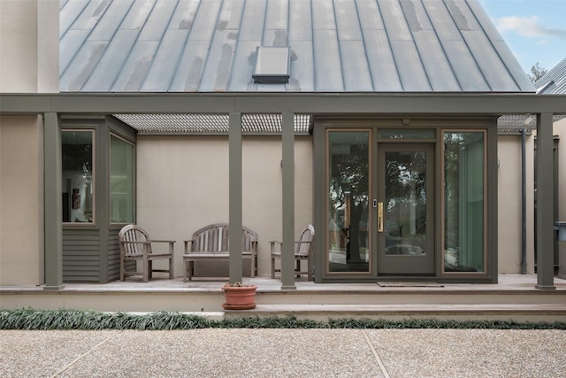 property entrance with metal roof and a standing seam roof