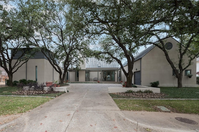 view of front of house featuring concrete driveway and stucco siding