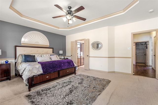 carpeted bedroom with a ceiling fan, a raised ceiling, and baseboards