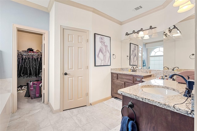 full bathroom featuring a spacious closet, vanity, visible vents, and ornamental molding