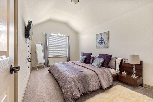 bedroom with light carpet, vaulted ceiling, and baseboards