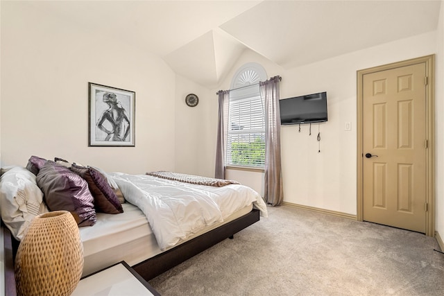 bedroom featuring light carpet, baseboards, and vaulted ceiling