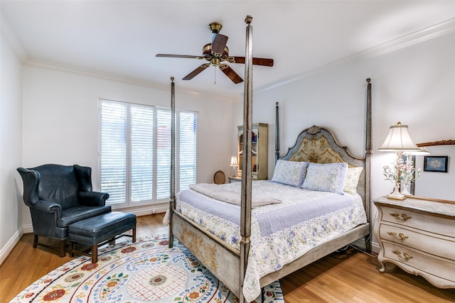 bedroom with baseboards, wood finished floors, a ceiling fan, and crown molding