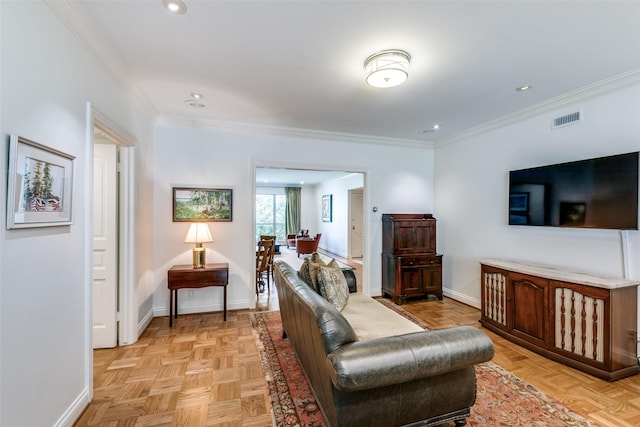 living room featuring baseboards, visible vents, and ornamental molding