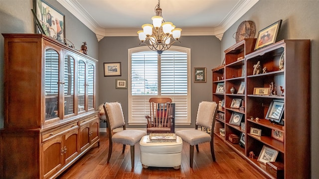 living area featuring wood-type flooring, a notable chandelier, and crown molding