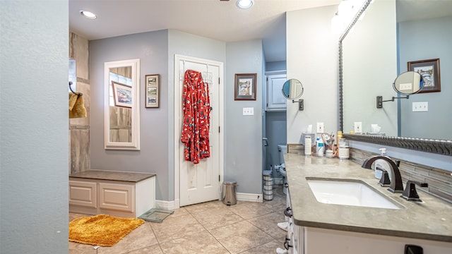 bathroom featuring baseboards, recessed lighting, vanity, and tile patterned floors